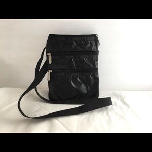 Le Sportsac crossbody black patent. 3 zippered compartments.